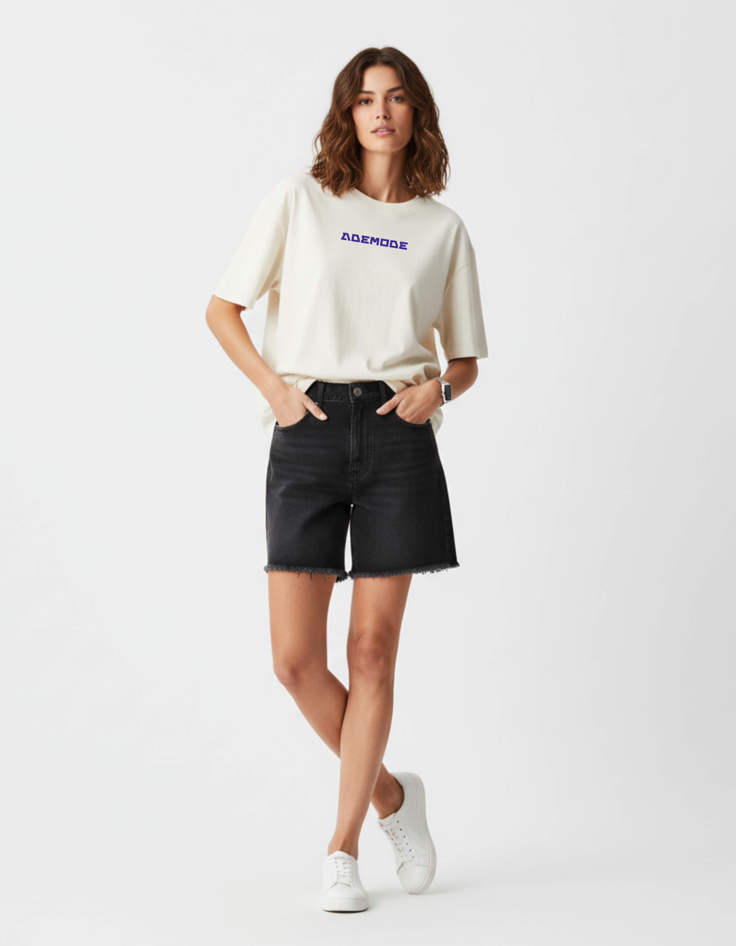 Woman wearing a white t-shirt with text and black shorts on a white background